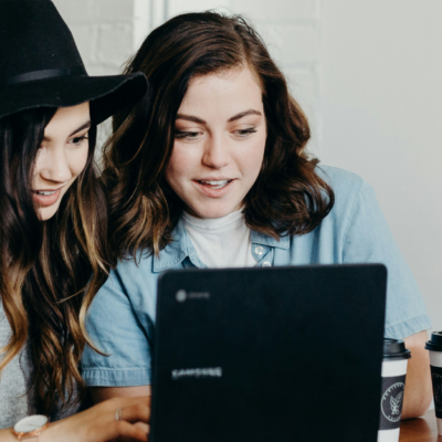 Two young women looking at a laptop