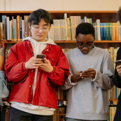 Students texting in the library