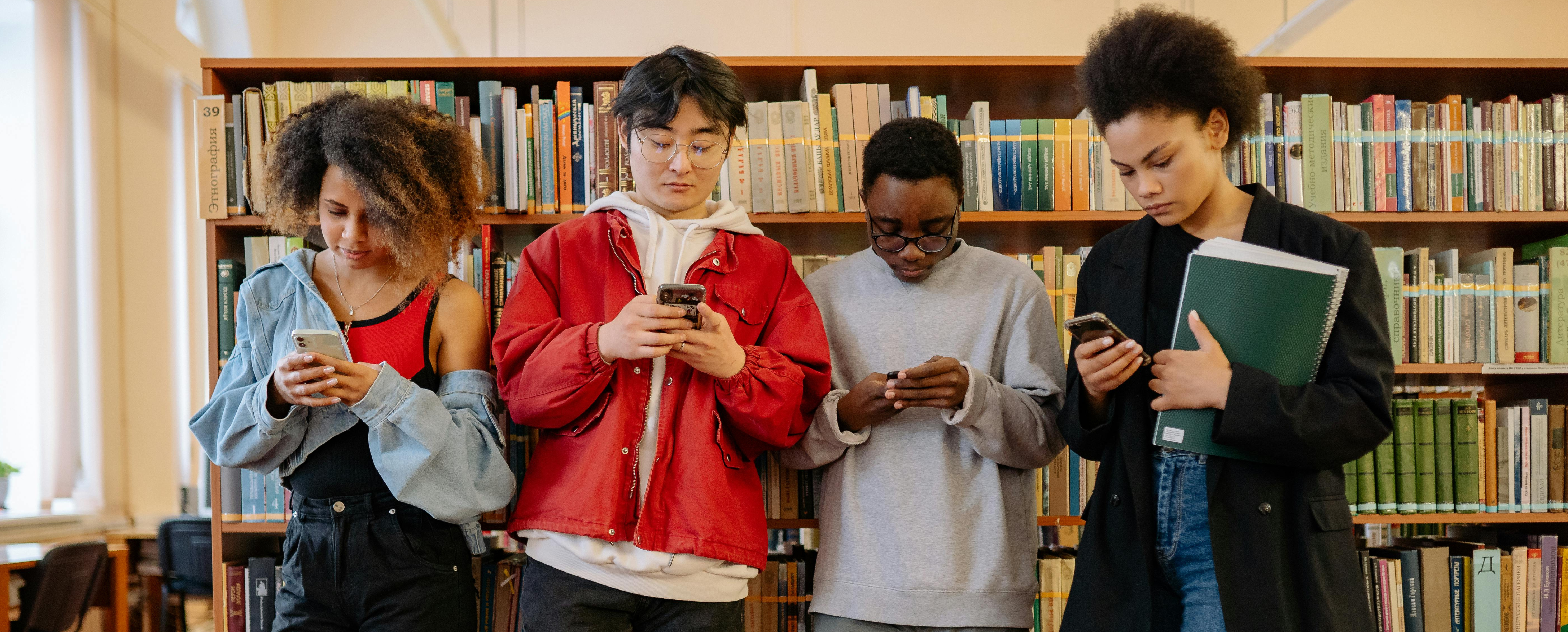 Students texting in the library